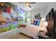 Charming bedroom with a playful Super Mario Bros themed mural, hardwood floors, and comfy king-size bed at 7739 Graben St, Kissimmee, FL 34747