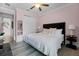 Beautiful bedroom with a plush bed, soft lighting, and view into the bathroom at 7739 Graben St, Kissimmee, FL 34747