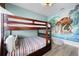 Bright bedroom featuring a bunk bed and a large mural wall at 7739 Graben St, Kissimmee, FL 34747