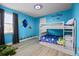 Bright blue bedroom featuring bunk beds, a playful 'Finding Nemo' theme, and light wood laminate floors at 7739 Graben St, Kissimmee, FL 34747