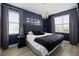 Stylish bedroom features a dark accent wall, modern lighting, and large windows at 7739 Graben St, Kissimmee, FL 34747