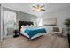 Bedroom featuring an accent wall, ceiling fan, and an upholstered chair by a window with natural light at 7739 Graben St, Kissimmee, FL 34747