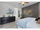 Spacious bedroom with wood laminate flooring, modern furnishings, and stylish world map decor at 7739 Graben St, Kissimmee, FL 34747