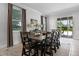 Spacious dining room featuring a long table, seating for ten, and a sliding glass door to the outdoor area at 7739 Graben St, Kissimmee, FL 34747