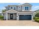 Stunning two-story home featuring a brick driveway, two-car garage, and neutral gray stucco exterior, complete with a red tiled roof at 7739 Graben St, Kissimmee, FL 34747