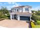 Charming two-story home with a well-manicured lawn, a two-car garage, and a tile roof at 7739 Graben St, Kissimmee, FL 34747