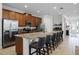 Modern kitchen with stainless steel appliances, granite countertops, and a large island with seating at 7739 Graben St, Kissimmee, FL 34747
