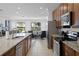 Well-equipped kitchen featuring an island, stainless steel appliances, and open access to the living area at 7739 Graben St, Kissimmee, FL 34747