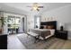 Spacious bedroom features luxury vinyl floors, ceiling fan, and sliding glass doors at 7739 Graben St, Kissimmee, FL 34747