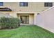 Cozy backyard featuring a green lawn, privacy fence, and sliding glass doors to indoor living space at 8187 Roseville Rd, Davenport, FL 33896