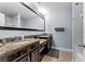 Bathroom with dual sinks, granite counters, a large mirror, and dark wood cabinets at 8187 Roseville Rd, Davenport, FL 33896