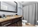 Bathroom featuring granite vanity, neutral paint, and shower with curtain at 8187 Roseville Rd, Davenport, FL 33896