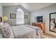 Inviting bedroom with vaulted ceilings, arched window, and modern decor at 8187 Roseville Rd, Davenport, FL 33896