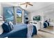 Light-filled bedroom with vaulted ceiling, feather accent wall, and a view to outdoor foliage from black-trimmed window at 8187 Roseville Rd, Davenport, FL 33896