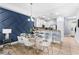 Bright dining area with a modern accent wall, stylish seating, and kitchen access at 8187 Roseville Rd, Davenport, FL 33896