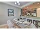 Open-concept dining area next to kitchen features stylish decor, modern lighting, and a cozy atmosphere at 8187 Roseville Rd, Davenport, FL 33896