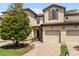 Charming townhome featuring a tile roof, brick driveway, and a one-car garage at 8187 Roseville Rd, Davenport, FL 33896