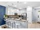 Stylish kitchen with a breakfast bar, white cabinetry, and stainless steel appliances at 8187 Roseville Rd, Davenport, FL 33896