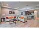 Cozy living area with tile flooring, sofas, and an open view to the kitchen and dining area at 8187 Roseville Rd, Davenport, FL 33896