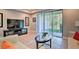 Bright living room with large sliding glass doors leading to a backyard view, filled with natural light at 8187 Roseville Rd, Davenport, FL 33896