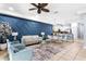 Spacious living area with stylish furniture, a decorative wall, and an open kitchen view at 8187 Roseville Rd, Davenport, FL 33896