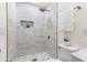 This renovated bathroom includes a custom shower and gold hardware at 88 E Charlotte Ave, Eustis, FL 32726
