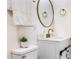 Bright bathroom features gold faucet, vanity, and round mirror at 88 E Charlotte Ave, Eustis, FL 32726