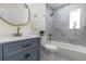 This renovated bathroom features blue vanity and granite shower at 88 E Charlotte Ave, Eustis, FL 32726