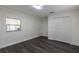 Bedroom featuring wood-look flooring, a window, and closet at 88 E Charlotte Ave, Eustis, FL 32726