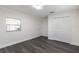 Minimalist bedroom with sleek flooring, white walls, ample closet space, and natural light at 88 E Charlotte Ave, Eustis, FL 32726