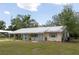 Charming single-story home with a covered porch, metal roof, and inviting curb appeal at 88 E Charlotte Ave, Eustis, FL 32726
