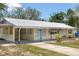 Attractive single-story home boasting a metal roof, covered entrance, and well-maintained landscaping at 88 E Charlotte Ave, Eustis, FL 32726