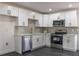 Bright kitchen featuring white cabinets, stainless steel appliances, quartz countertops, and gold hardware at 88 E Charlotte Ave, Eustis, FL 32726