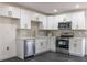 Modern kitchen featuring white cabinets, stainless steel appliances, and sleek countertops at 88 E Charlotte Ave, Eustis, FL 32726