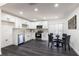 Updated kitchen with white cabinetry, stainless steel appliances, and adjacent dining area at 88 E Charlotte Ave, Eustis, FL 32726
