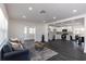 Open-concept living space with dark floors, white walls, stainless steel appliances, and recessed lighting at 88 E Charlotte Ave, Eustis, FL 32726