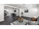 Open-concept living space featuring dark floors, white walls, recessed lighting, and modern furniture at 88 E Charlotte Ave, Eustis, FL 32726