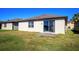 Exterior view of home showing backyard with sliding glass door leading to patio at 8933 Hinsdale Heights Dr, Polk City, FL 33868