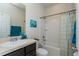 Well-lit bathroom featuring a vanity, commode, shower and tub combination with curtain and decorative art at 8933 Hinsdale Heights Dr, Polk City, FL 33868