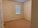Cozy bedroom featuring neutral walls, carpeted floors, and a window at 8933 Hinsdale Heights Dr, Polk City, FL 33868