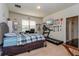 Bright bedroom with a large window, desk area, and exercise equipment at 8933 Hinsdale Heights Dr, Polk City, FL 33868