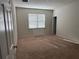 Comfortable carpeted bedroom with natural light and a walk-in closet at 8933 Hinsdale Heights Dr, Polk City, FL 33868