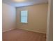 This bedroom offers neutral walls, carpeted floors, and a window allowing for natural light at 8933 Hinsdale Heights Dr, Polk City, FL 33868