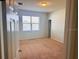 Bright bedroom features a large window for natural light and neutral carpeting at 8933 Hinsdale Heights Dr, Polk City, FL 33868
