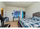 Bedroom featuring a comfortable bed, ample natural light, and modern decor with a treadmill at 8933 Hinsdale Heights Dr, Polk City, FL 33868