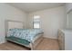 Comfortable bedroom featuring neutral tones, plush carpeting, and a large window for natural light at 8933 Hinsdale Heights Dr, Polk City, FL 33868