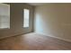 Bedroom featuring neutral carpet, white walls, and large window at 8933 Hinsdale Heights Dr, Polk City, FL 33868