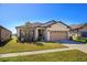 Charming single-story home with a manicured lawn, beautiful landscaping, and a two-car garage at 8933 Hinsdale Heights Dr, Polk City, FL 33868