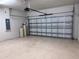 Spacious garage with epoxy flooring and a garage door at 8933 Hinsdale Heights Dr, Polk City, FL 33868