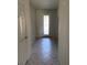Inviting hallway with decorative front door and neutral tile flooring at 8933 Hinsdale Heights Dr, Polk City, FL 33868